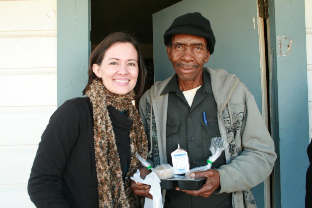 Volunteer with Client Receiving Meal